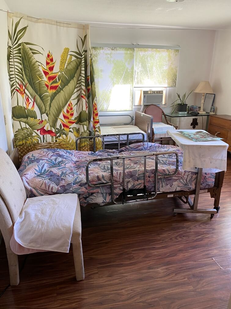 eden carehome bedroom with wooden floor and a made bed
